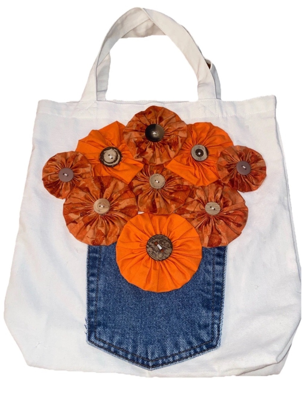 Handmade white canvas tote bag orange fabric flowers attached to a denim pocket‎